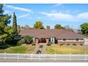 Beautiful home with a manicured front lawn and a charming white picket fence at 3160 E Fox St, Mesa, AZ 85213