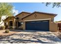 Charming single-story home featuring a well-maintained landscape and a two-car garage at 3233 N 137Th Dr, Avondale, AZ 85392