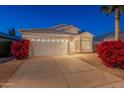 Charming single-story home with a well-maintained front yard and two-car garage at dusk at 3522 E Edna Ave, Phoenix, AZ 85032