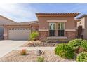 Charming single-story home with stone accents and a well-maintained desert-landscaped front yard at 35306 N 31St Dr, Phoenix, AZ 85086