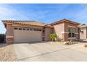 Single-story home with a desert landscape, garage and tile roof. A well-maintained front yard at 35306 N 31St Dr, Phoenix, AZ 85086