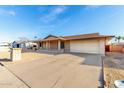 Single-story home with a brick facade, spacious driveway, and low-maintenance desert landscaping at 3635 W Cortez St, Phoenix, AZ 85029