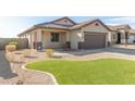 Attractive single-story home featuring desert landscaping, a tile roof, and a two-car garage at 37808 N Pagoda Ln, Phoenix, AZ 85086