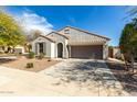 Single story home with two-car garage, desert landscaping, and a tile roof on a sunny day at 3781 S Pablo Pass Dr, Gilbert, AZ 85297