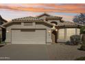 Inviting home with warm exterior lighting, two-car garage, and desert landscaping at 3804 E Encinas Ave, Gilbert, AZ 85234