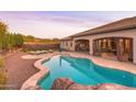 Sparkling backyard pool surrounded by a patio, lounge chairs, and desert landscaping at 39610 N 12Th St, Phoenix, AZ 85086