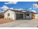 Charming exterior showcasing a well-maintained home with a two-car garage and landscaped front yard at 42 E 14Th St, Mesa, AZ 85201