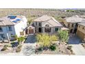 A view of a beige tile roof home, showcasing desert landscaping and a concrete driveway at 42829 N Livingstone Way, Anthem, AZ 85086