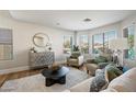 Cozy living room with neutral colors, hardwood floors, and comfortable seating at 43819 W Wolf Dr, Maricopa, AZ 85138