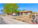 Inviting single-story home with well-maintained landscaping, brick accents, and a mailbox with house numbers at 5216 W Beryl Ave, Glendale, AZ 85302