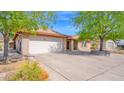 Lovely single-story home with a brick exterior, a two-car garage, and a well-kept lawn at 5216 W Beryl Ave, Glendale, AZ 85302