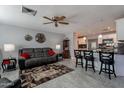 Open-concept living room with modern tile flooring and seamless flow to the kitchen at 555 Leisure World --, Mesa, AZ 85206