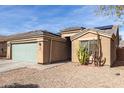 View of a single story house featuring xeriscaping and solar panels on the roof at 562 W Enchanted Desert Dr, Casa Grande, AZ 85122