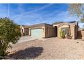 View of a single story house featuring xeriscaping and solar panels on the roof at 562 W Enchanted Desert Dr, Casa Grande, AZ 85122