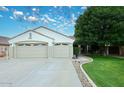 Charming home featuring a convenient three-car garage and beautiful landscaping at 5624 E Garnet Ave, Mesa, AZ 85206
