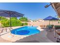 Beautiful backyard featuring a private pool, lush landscaping, and patio furniture at 5624 E Garnet Ave, Mesa, AZ 85206