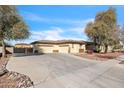 Charming single-story home featuring a three-car garage and mature trees at 5634 N 82 Ave, Glendale, AZ 85303