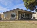 Enjoy outdoor living on this home's covered patio, complete with privacy fence, and desert themed decor at 650 N Hawes Rd # 2852, Mesa, AZ 85207