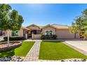 Charming home with desert landscaping and artificial turf for low maintenance curb appeal at 6543 E Preston St, Mesa, AZ 85215