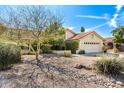 Single-story home featuring desert landscaping, a two-car garage, and a red tile roof on a sunny day at 817 E Meadow Ln, Phoenix, AZ 85022