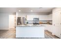 Bright kitchen showcasing stainless steel appliances and a central island with granite countertops at 821 S Parker Pl, Casa Grande, AZ 85122