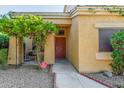 Home's inviting front entry features a charming courtyard with lush plants and decorative accents at 8305 W Pioneer St, Tolleson, AZ 85353