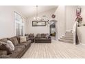 Bright living room boasts high ceilings, tile floors, and staircase access for a seamless flow at 8305 W Pioneer St, Tolleson, AZ 85353