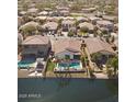 Aerial view of backyards showing pools and water views of homes in the neighborhood at 856 E Indian Wells Pl, Chandler, AZ 85249