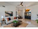 Cozy living room with comfortable seating, stylish decor, and view of the dining room through an arched doorway at 9214 N 83Rd St, Scottsdale, AZ 85258