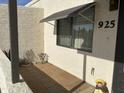 Inviting front entrance featuring a shaded porch with stylish tile and decorative accents at 925 E Lancaster Cir, Florence, AZ 85132