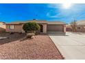 Single level home showcasing desert landscaping, a two car garage, and a front entrance with gate at 9283 W Rafael Dr, Arizona City, AZ 85123