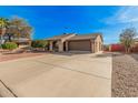 Expansive driveway leading to a single level home with desert landscaping and a two car garage at 9283 W Rafael Dr, Arizona City, AZ 85123