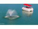 Leisure pontoon boat with fountain feature in the water at 10116 W Bolivar Dr, Sun City, AZ 85351