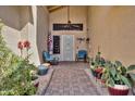 Inviting front porch with plants and seating, leading to the home's entrance, creating a welcoming atmosphere at 13601 S 37Th St, Phoenix, AZ 85044