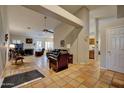 Spacious living room with high ceilings, terracotta tile floors, and comfortable seating, perfect for entertaining at 13601 S 37Th St, Phoenix, AZ 85044