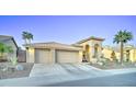 Desert home featuring a barrel tile roof, a three-car garage, and drought-tolerant landscaping at 1414 E Amberwood Dr, Phoenix, AZ 85048