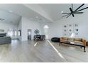 Bright, open-concept living space featuring wood-look floors, high ceilings, and plenty of natural light at 1414 E Amberwood Dr, Phoenix, AZ 85048