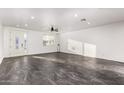 Spacious living room featuring a modern ceiling fan, white walls, a large window, and gray tile flooring at 1625 S 113Th Ave, Avondale, AZ 85323