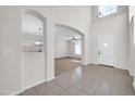 Bright foyer featuring tile flooring, high ceilings, and an arched entryway to the living area at 17388 W Elaine Dr, Goodyear, AZ 85338