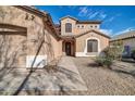 Inviting two-story home showcasing a well-maintained front yard and cozy entrance at 17388 W Elaine Dr, Goodyear, AZ 85338