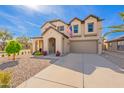 Attractive two-story home showcasing an attached two-car garage and desert landscaping at 17722 N 183Rd Ave, Surprise, AZ 85374