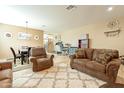 Cozy living room featuring comfortable seating, a patterned rug, and an adjacent dining area at 17722 N 183Rd Ave, Surprise, AZ 85374