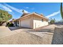 A single story home shows its brick and shingle siding, attached garage and walkway on the side of the house at 17807 N 126Th Dr, Sun City West, AZ 85375