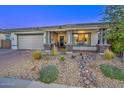Charming single-story home with desert landscaping, covered front porch, and two-car garage at 18207 W Hope Dr, Goodyear, AZ 85338