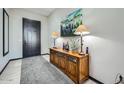 Inviting entryway featuring a stylish wooden console table, decorative lamps, and an elegant painting at 19140 N 259Th Ave, Buckeye, AZ 85396