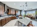 Modern kitchen with granite countertops, stainless steel appliances, and a spacious center island at 19140 N 259Th Ave, Buckeye, AZ 85396