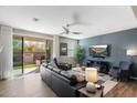 Inviting living room with modern furniture, a ceiling fan and sliding door access to the backyard at 1929 S Follett Way, Gilbert, AZ 85295