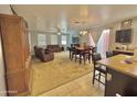 Spacious living and dining area with open floor plan, carpet and neutral color scheme at 2019 N 78Th Ave, Phoenix, AZ 85035
