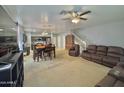 Bright and airy living room with plush seating, carpet and an open staircase at 2019 N 78Th Ave, Phoenix, AZ 85035