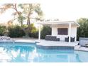 Sparkling pool with an adjacent covered lounge area featuring a television and hot tub at 2113 E Glencove St, Mesa, AZ 85213